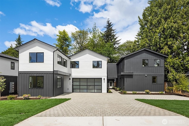 10304 NE 113th Pl, Kirkland, WA 98033 - view of front of home featuring decorative driveway, a garage, a front lawn, and board and batten siding