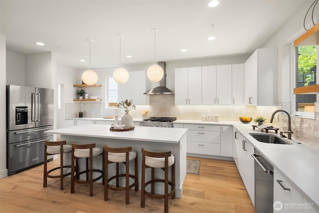 10304 NE 113th Pl, Kirkland, WA 98033 - kitchen with stainless steel appliances, a sink, wall chimney exhaust hood, a center island, and decorative backsplash