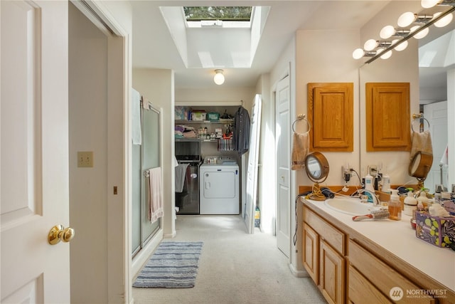 14904 108th Pl NE, Bothell, WA 98011 - full bathroom featuring washing machine and clothes dryer, a skylight, vanity, a shower stall, and healthy amount of natural light