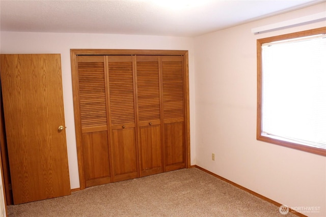 19494 N N Pl, Long Beach, WA 98631 - unfurnished bedroom featuring light colored carpet, a closet, and baseboards