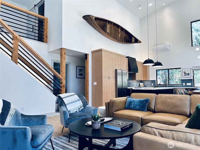 7400 Miller Way, Glacier, WA 98244 - living room with a high ceiling, stairway, light wood-style floors, recessed lighting, and a wall unit AC