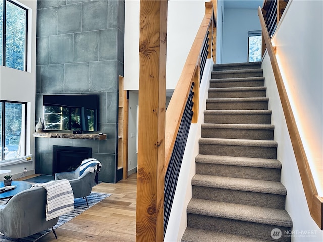 7400 Miller Way, Glacier, WA 98244 - staircase with a large fireplace, wood finished floors, and plenty of natural light