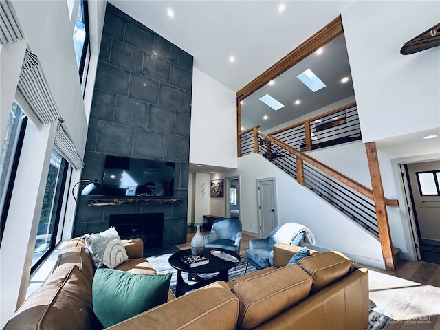 7400 Miller Way, Glacier, WA 98244 - living room featuring a high ceiling, a tiled fireplace, stairway, healthy amount of natural light, and recessed lighting