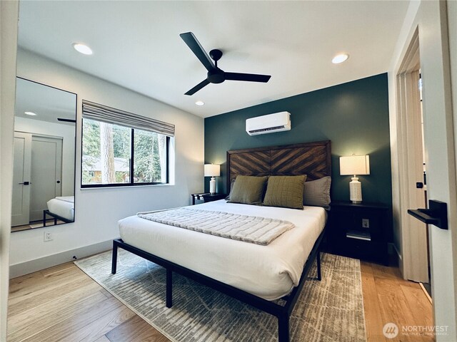 7400 Miller Way, Glacier, WA 98244 - bedroom with an AC wall unit, wood finished floors, recessed lighting, a ceiling fan, and baseboards