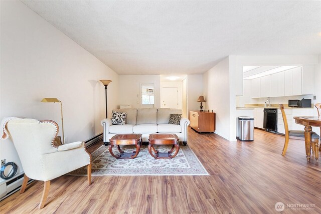 5565 E Evergreen Blvd Unit 3104, Vancouver, WA 98661 - living area with light wood-style floors and a baseboard heating unit