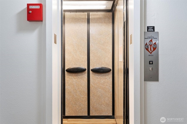 5565 E Evergreen Blvd Unit 3104, Vancouver, WA 98661 - elevator featuring a textured wall and a fire alarm