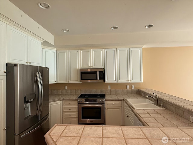 1805 134th Ave NE Unit 8, Bellevue, WA 98005 - kitchen featuring stainless steel appliances, a sink, tile counters, a peninsula, and recessed lighting
