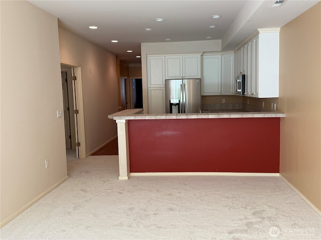 1805 134th Ave NE Unit 8, Bellevue, WA 98005 - kitchen with appliances with stainless steel finishes, tile counters, light carpet, white cabinets, and recessed lighting