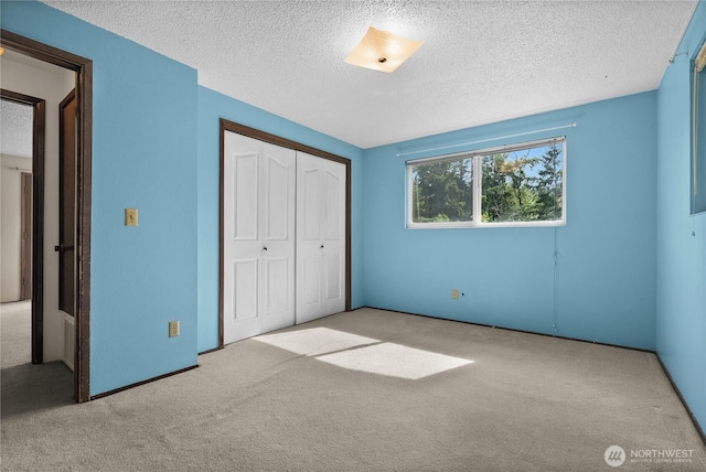 12012 County Line Rd E, Edgewood, WA 98372 - unfurnished bedroom featuring carpet flooring, a textured ceiling, and a closet