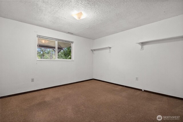 12012 County Line Rd E, Edgewood, WA 98372 - carpeted spare room featuring a textured ceiling and baseboards