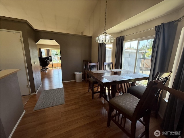 11426 SE 307th Pl, Auburn, WA 98092 - dining room featuring a chandelier, arched walkways, healthy amount of natural light, wood finished floors, and high vaulted ceiling