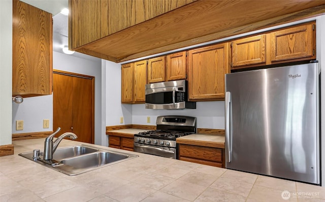 873 Fern Dr, Lynden, WA 98264 - kitchen with appliances with stainless steel finishes, a sink, and brown cabinets
