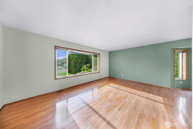 873 Fern Dr, Lynden, WA 98264 - spare room featuring plenty of natural light, hardwood / wood-style flooring, and baseboards