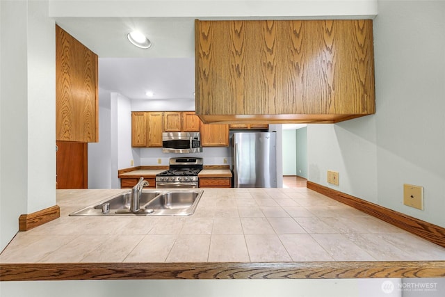 873 Fern Dr, Lynden, WA 98264 - kitchen featuring stainless steel appliances, a sink, brown cabinets, recessed lighting, and a peninsula