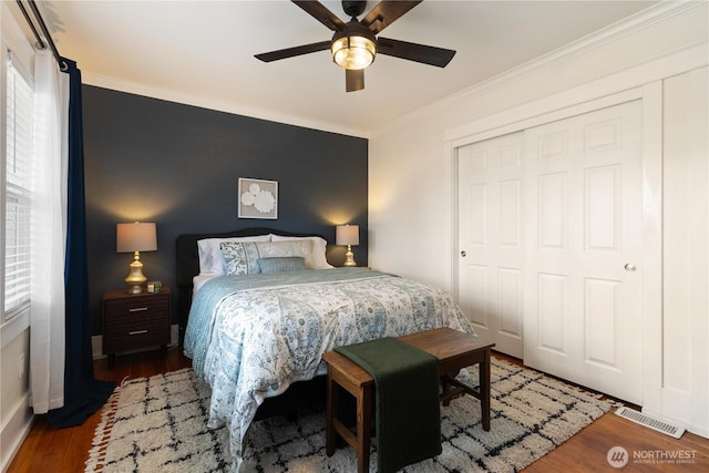 707 N Adams St, Tacoma, WA 98406 - bedroom with crown molding, wood finished floors, baseboards, ceiling fan, and a closet