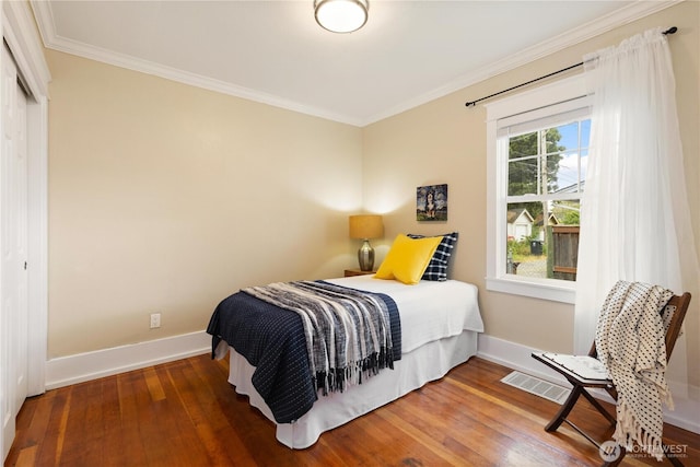 707 N Adams St, Tacoma, WA 98406 - bedroom featuring ornamental molding, wood finished floors, baseboards, and a closet