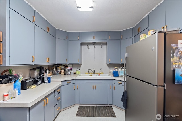 973 US Highway 101, Cosmopolis, WA 98537 - kitchen featuring freestanding refrigerator, a sink, and light countertops