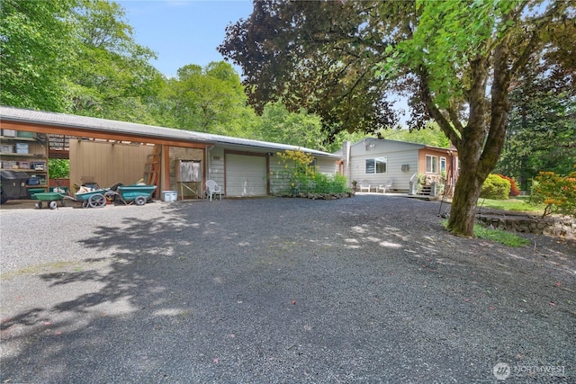 973 US Highway 101, Cosmopolis, WA 98537 - view of front facade featuring a garage, driveway, an outdoor structure, and entry steps