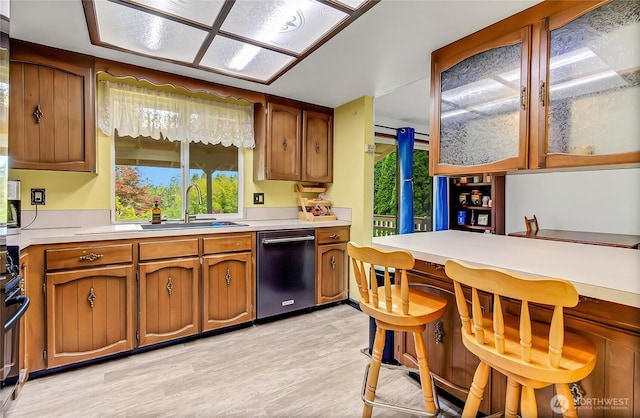 4701 161st St E, Tacoma, WA 98446 - kitchen featuring dishwasher, light countertops, brown cabinetry, and plenty of natural light