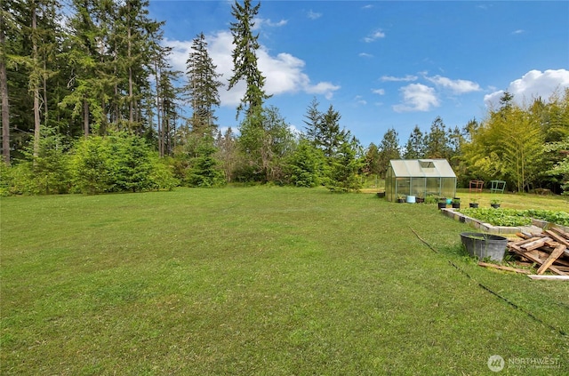 4701 161st St E, Tacoma, WA 98446 - view of green lawn with a greenhouse and an outbuilding