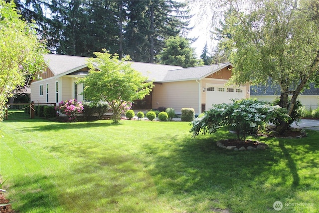 17247 154th Ave SE, Yelm, WA 98597 - view of front of house featuring an attached garage, a front lawn, and board and batten siding