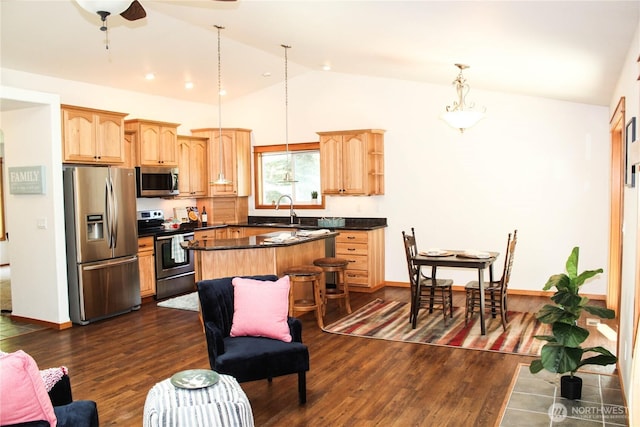 17247 154th Ave SE, Yelm, WA 98597 - kitchen featuring stainless steel appliances, a center island, lofted ceiling, light brown cabinets, and dark countertops