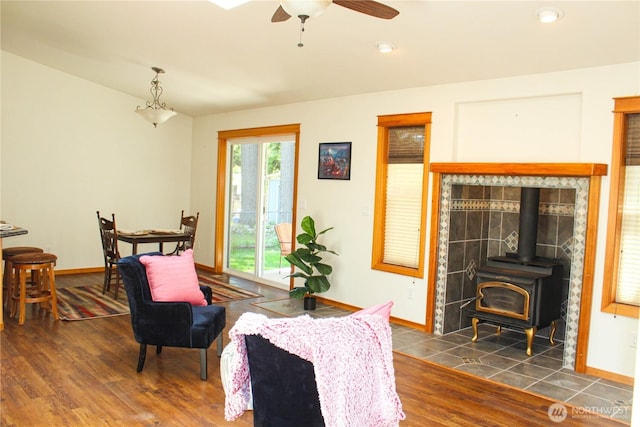 17247 154th Ave SE, Yelm, WA 98597 - living room featuring a wood stove, wood finished floors, baseboards, ceiling fan, and recessed lighting