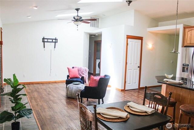 17247 154th Ave SE, Yelm, WA 98597 - dining area featuring dark wood-type flooring, a ceiling fan, washer / clothes dryer, lofted ceiling, and baseboards
