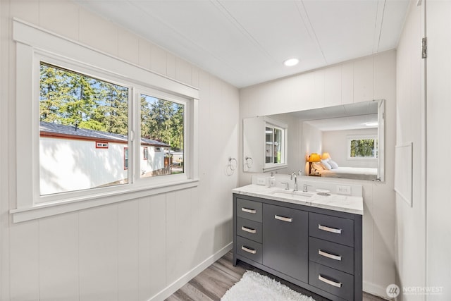 12615 113th St E Unit 249, Puyallup, WA 98374 - bathroom with vanity, wood finished floors, healthy amount of natural light, and baseboards