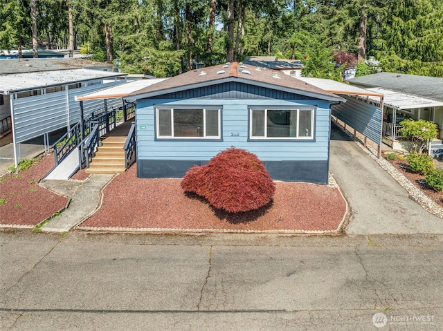 12615 113th St E Unit 249, Puyallup, WA 98374 - view of front of house with a carport and asphalt driveway