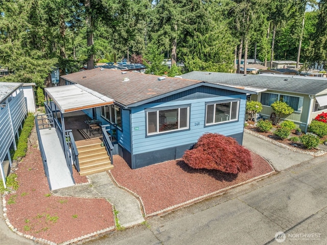 12615 113th St E Unit 249, Puyallup, WA 98374 - view of front of home featuring a shingled roof and stairway
