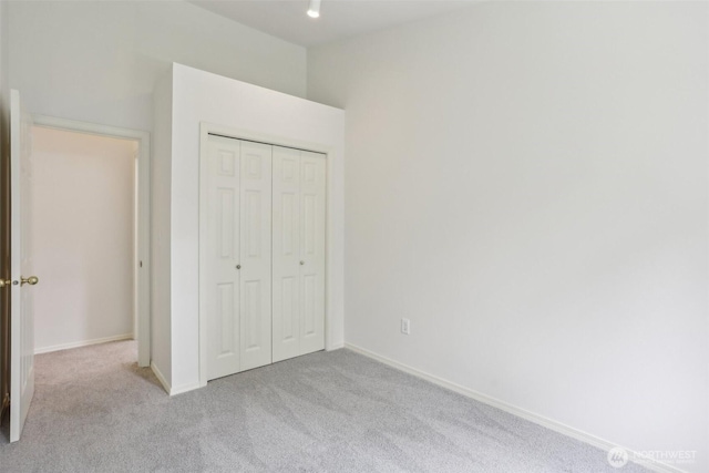21616 9th Ave SE Unit C-105, Bothell, WA 98021 - unfurnished bedroom with carpet flooring, a closet, and baseboards