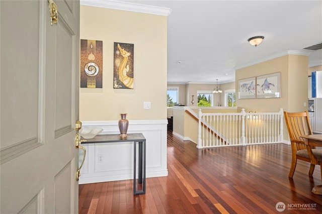12232 SE 80th Way, Newcastle, WA 98056 - hall with an upstairs landing, hardwood / wood-style floors, crown molding, wainscoting, and a chandelier