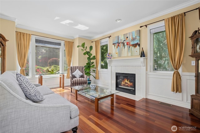 12232 SE 80th Way, Newcastle, WA 98056 - living area with a fireplace, healthy amount of natural light, wood finished floors, and crown molding