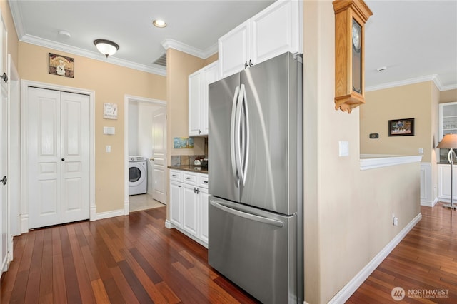 12232 SE 80th Way, Newcastle, WA 98056 - kitchen with freestanding refrigerator, washer / clothes dryer, ornamental molding, dark wood finished floors, and white cabinets