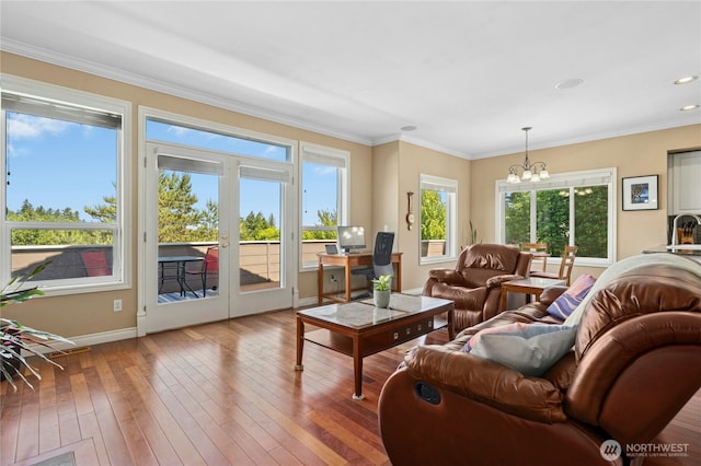 12232 SE 80th Way, Newcastle, WA 98056 - living room featuring a chandelier, baseboards, french doors, wood-type flooring, and crown molding