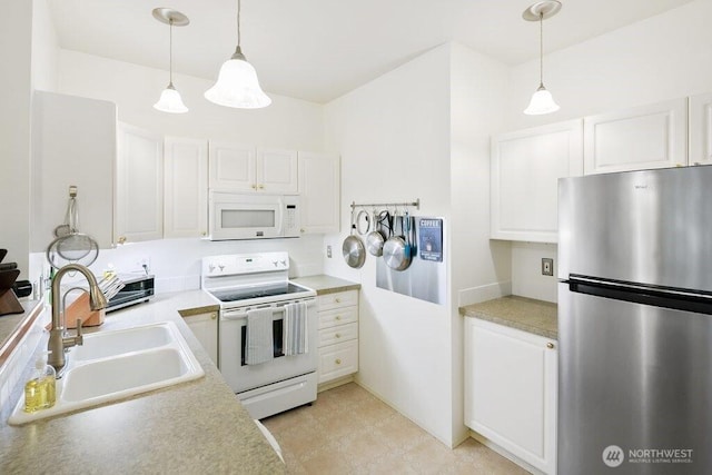 12712 Admiralty Way Unit G102, Everett, WA 98204 - kitchen featuring white appliances, a sink, white cabinets, light countertops, and decorative light fixtures