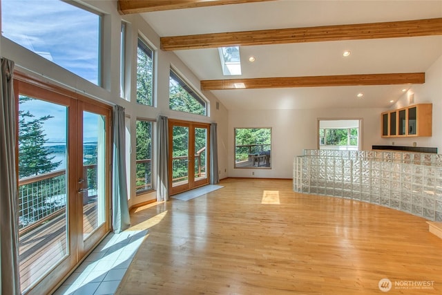 121 Switchback Rd, Orcas Island, WA 98245 - unfurnished living room with french doors, a skylight, light wood finished floors, and recessed lighting