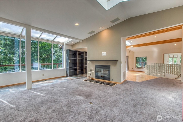 121 Switchback Rd, Orcas Island, WA 98245 - unfurnished living room featuring vaulted ceiling, carpet, a fireplace with flush hearth, baseboards, and recessed lighting