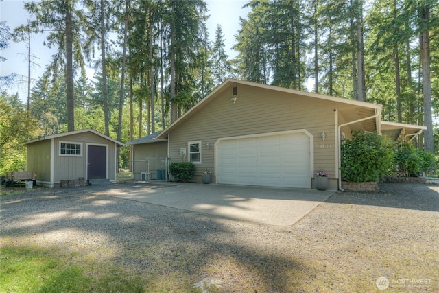6610 6th Ave SE, Lacey, WA 98503 - view of side of home featuring concrete driveway, an outbuilding, and a garage