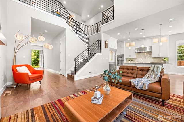 21888 SE 5th Pl, Sammamish, WA 98074 - living area featuring hardwood / wood-style floors, baseboards, healthy amount of natural light, stairway, and recessed lighting