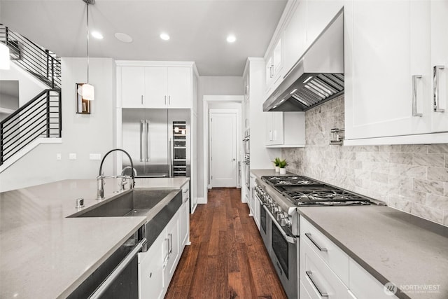 21888 SE 5th Pl, Sammamish, WA 98074 - kitchen with extractor fan, premium appliances, white cabinetry, dark wood-style flooring, and recessed lighting