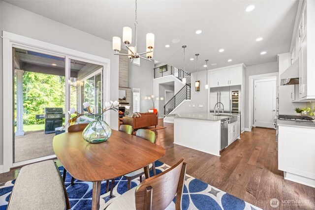 21888 SE 5th Pl, Sammamish, WA 98074 - dining space featuring recessed lighting, dark wood-type flooring, a chandelier, and stairway