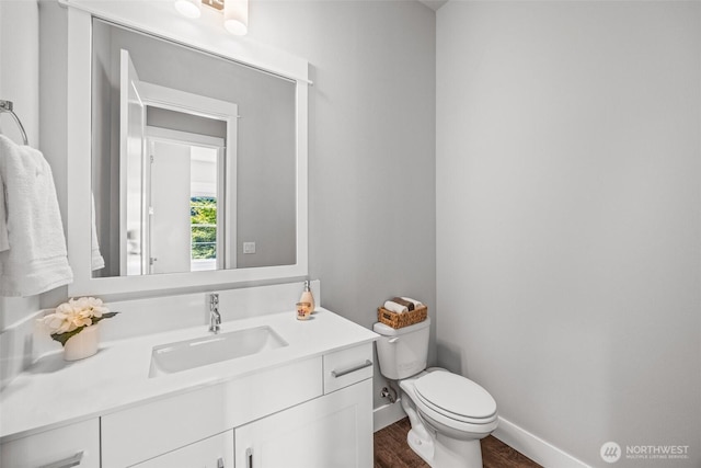 21888 SE 5th Pl, Sammamish, WA 98074 - half bath featuring vanity, toilet, wood finished floors, and baseboards