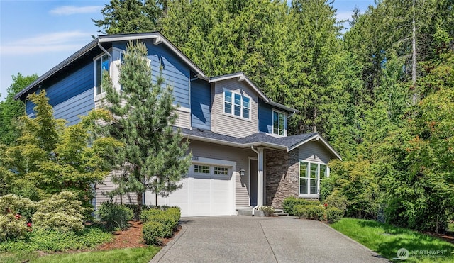 21888 SE 5th Pl, Sammamish, WA 98074 - view of front of home with an attached garage, concrete driveway, and stone siding