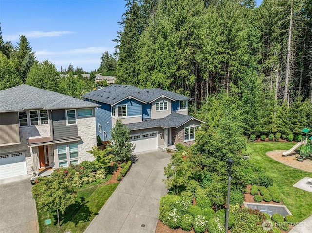 21888 SE 5th Pl, Sammamish, WA 98074 - view of front facade featuring stone siding, concrete driveway, a garage, a playground, and a front lawn