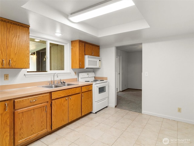 17509 16th Ave E, Spanaway, WA 98387 - kitchen with white appliances, a sink, a tray ceiling, and light countertops