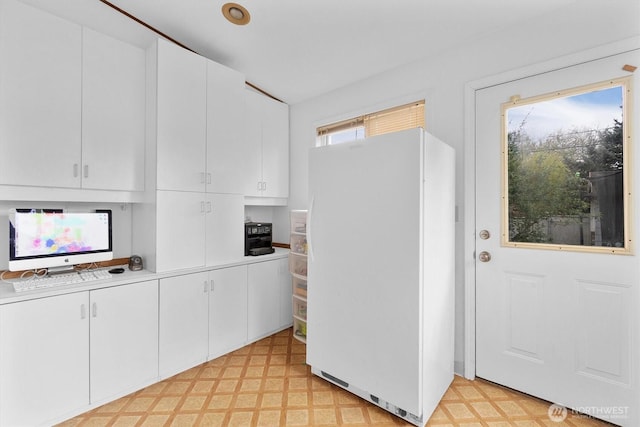 1228 22nd Ave, Longview, WA 98632 - kitchen with freestanding refrigerator, light flooring, light countertops, and white cabinetry