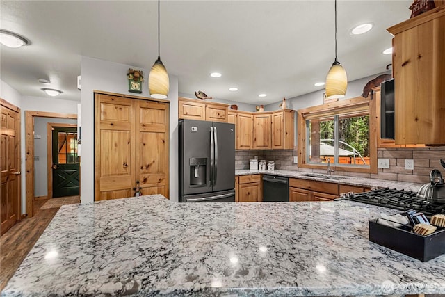 18880 Pine Loop, Leavenworth, WA 98826 - kitchen featuring stainless steel fridge, a sink, black dishwasher, light stone countertops, and tasteful backsplash