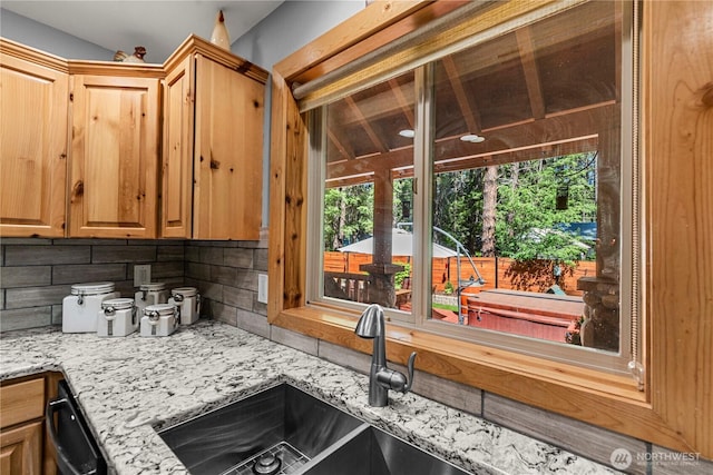 18880 Pine Loop, Leavenworth, WA 98826 - kitchen featuring tasteful backsplash, a sink, light stone counters, and dishwasher